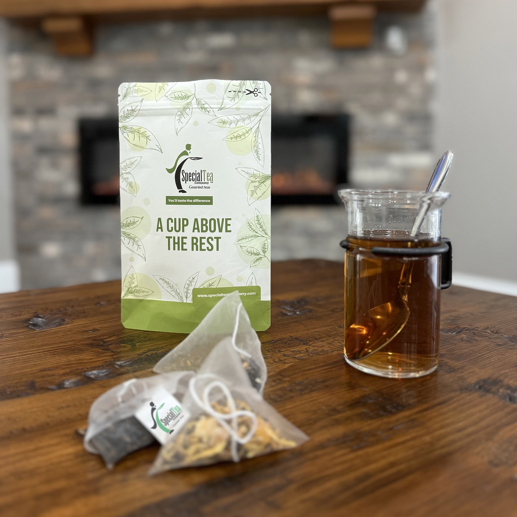 Special Tea package with a glass of tea and teabags on a wooden surface.